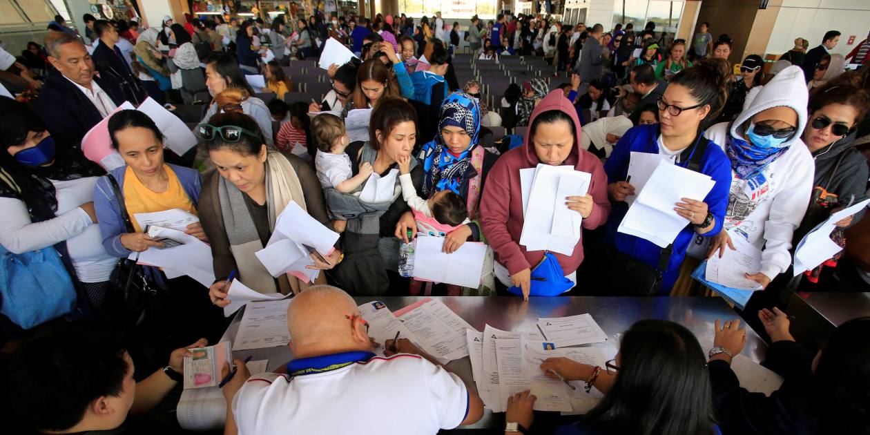 Kuwait-bound Filipino migrants left stranded by entry ban